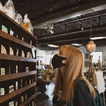 Store open during covid. Employee wearing a mask
